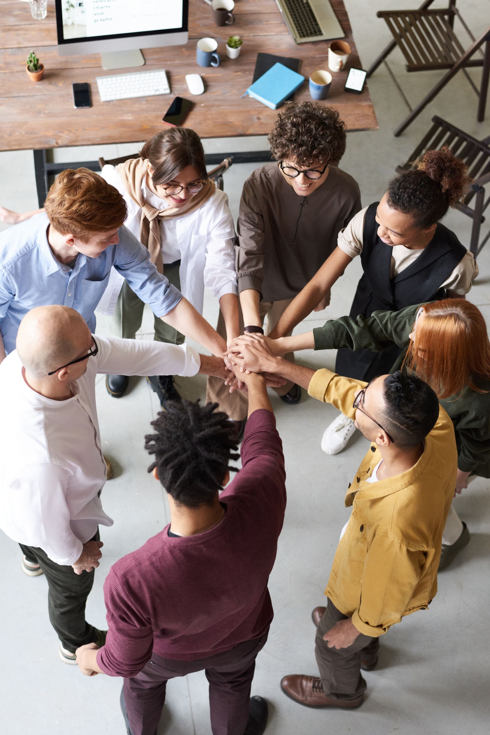 Team joining hands at work