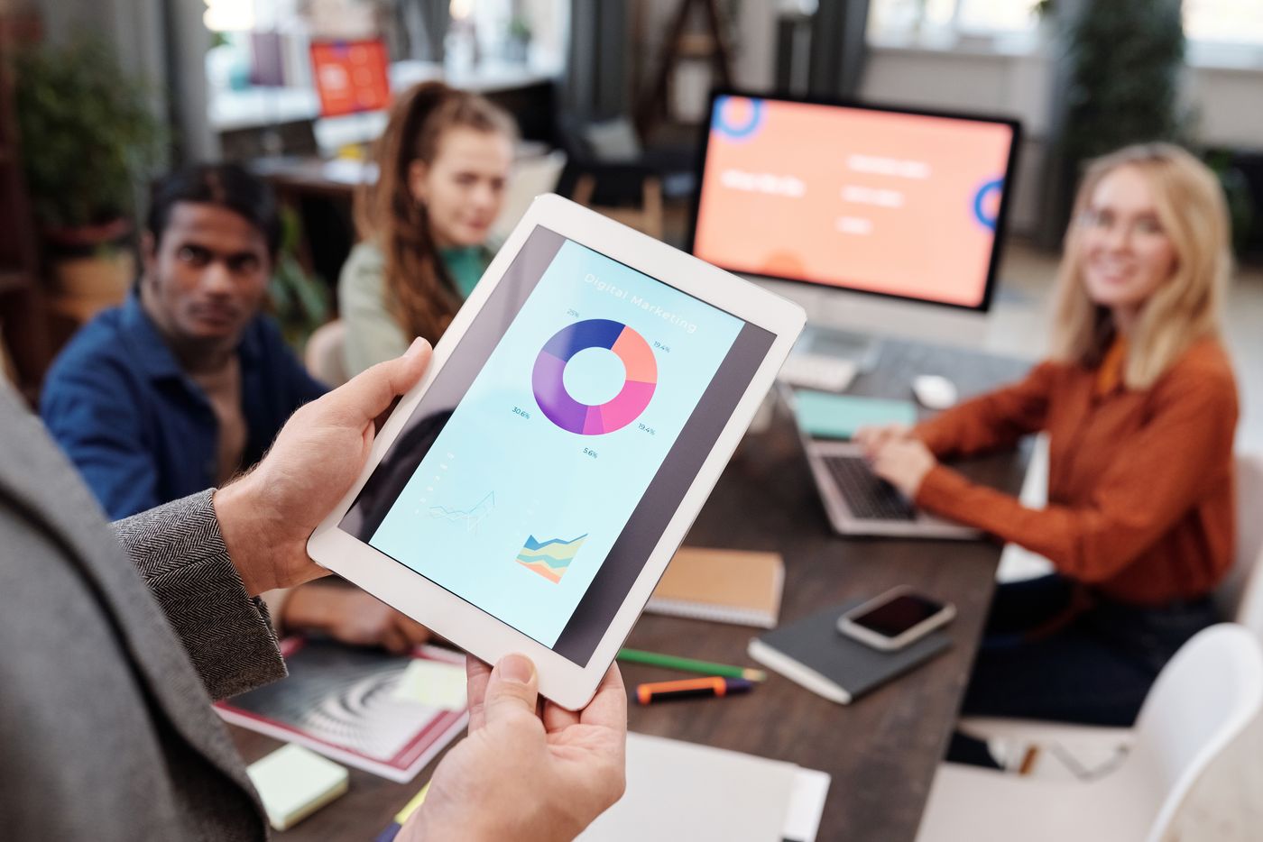 Marketing engagement data reviewed on a tablet